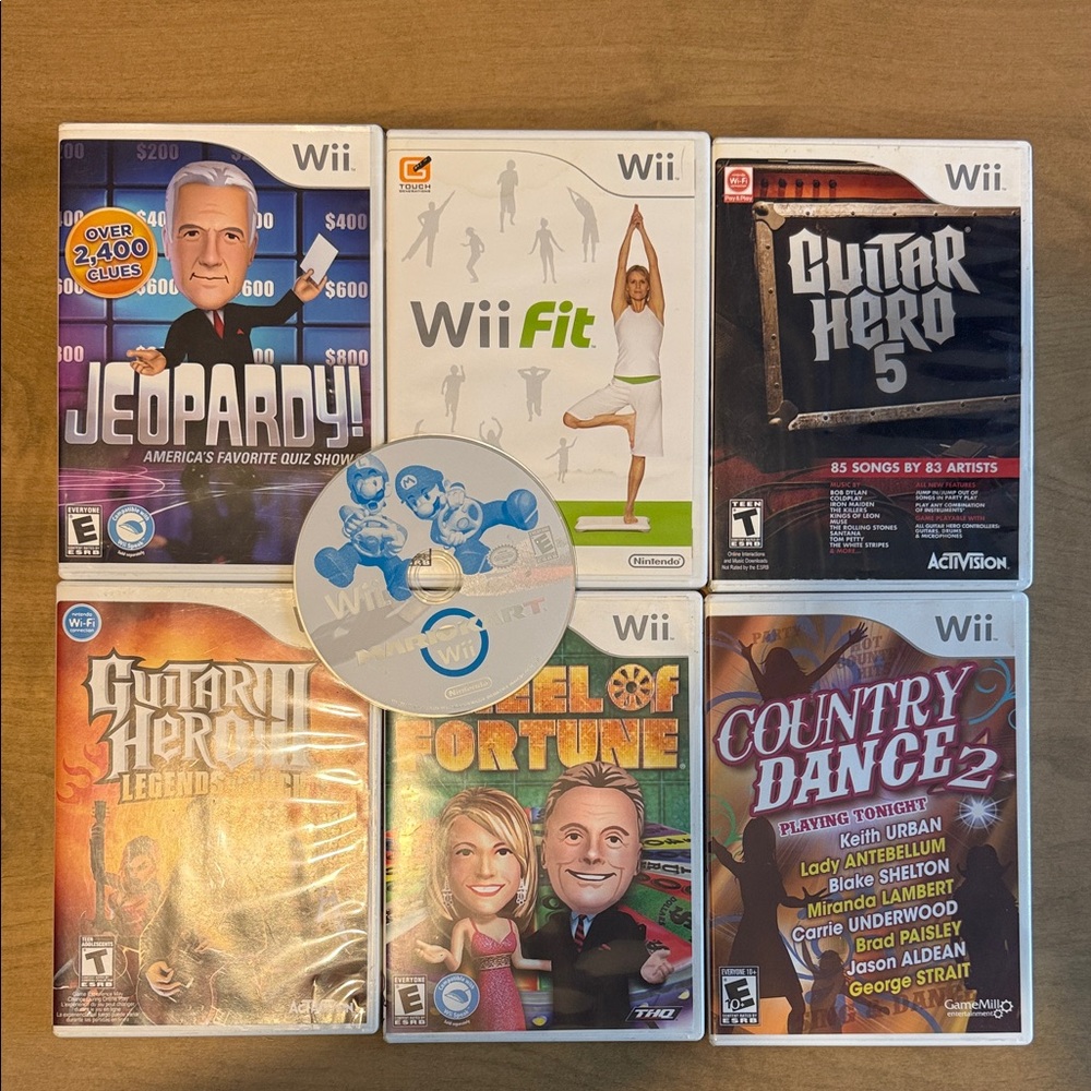 Lot of 7 Nintendo Wii Game Bundle, 2 Wii remotes, and 2 nunchucks